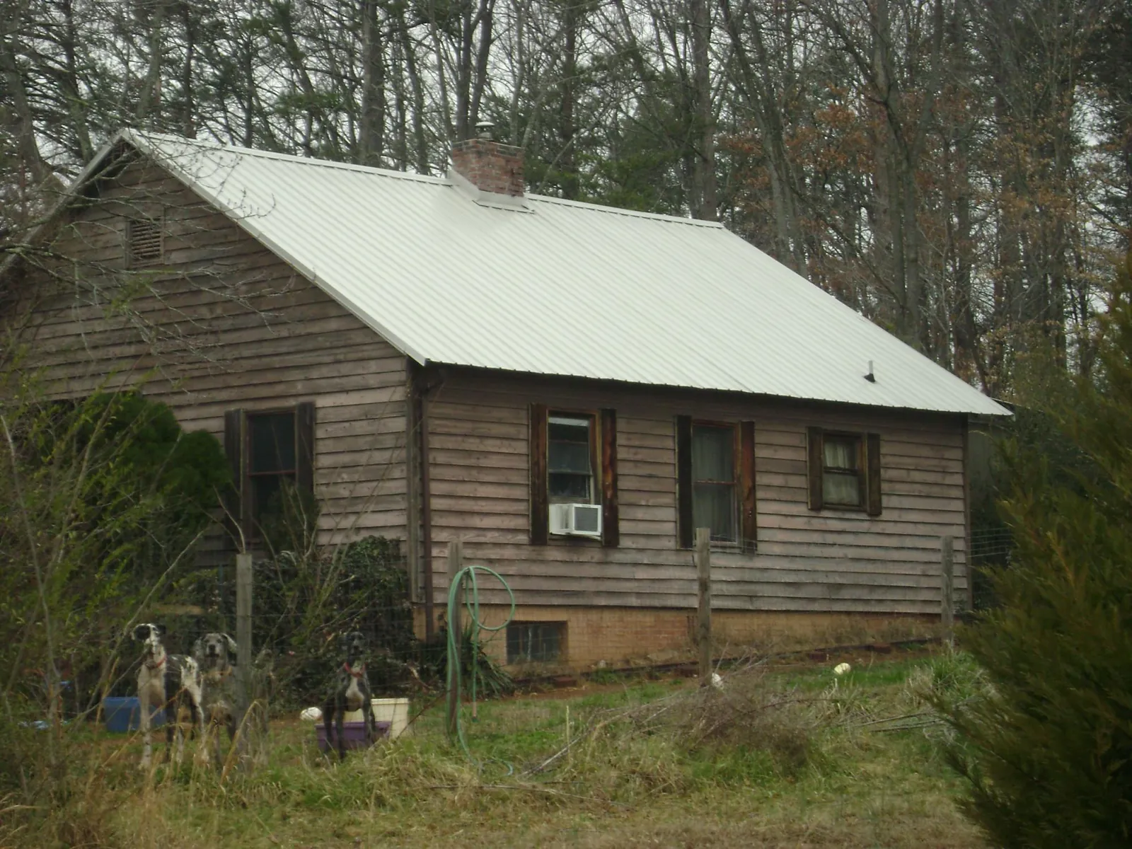 White metal roof on an old wood sided farmhouse, from a Metal Roof Installation job in Fabius
